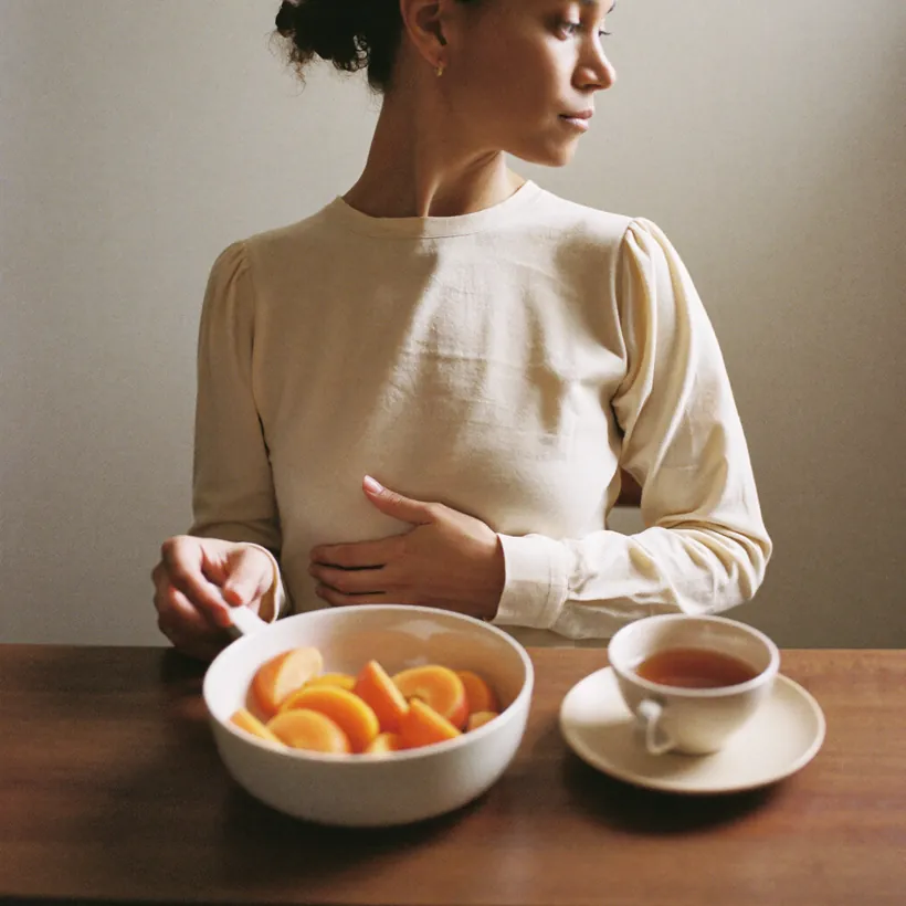 Reaching for a fruit bowl at the table
